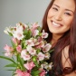 young-woman-smiling-with-a-bouquet_1098-659